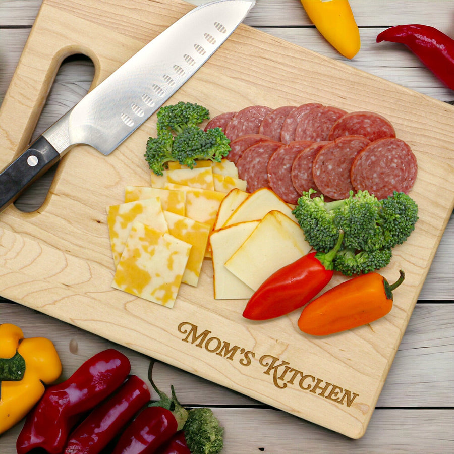 Personalized Mom's Kitchen board holding cheese, vegetables and a knife
