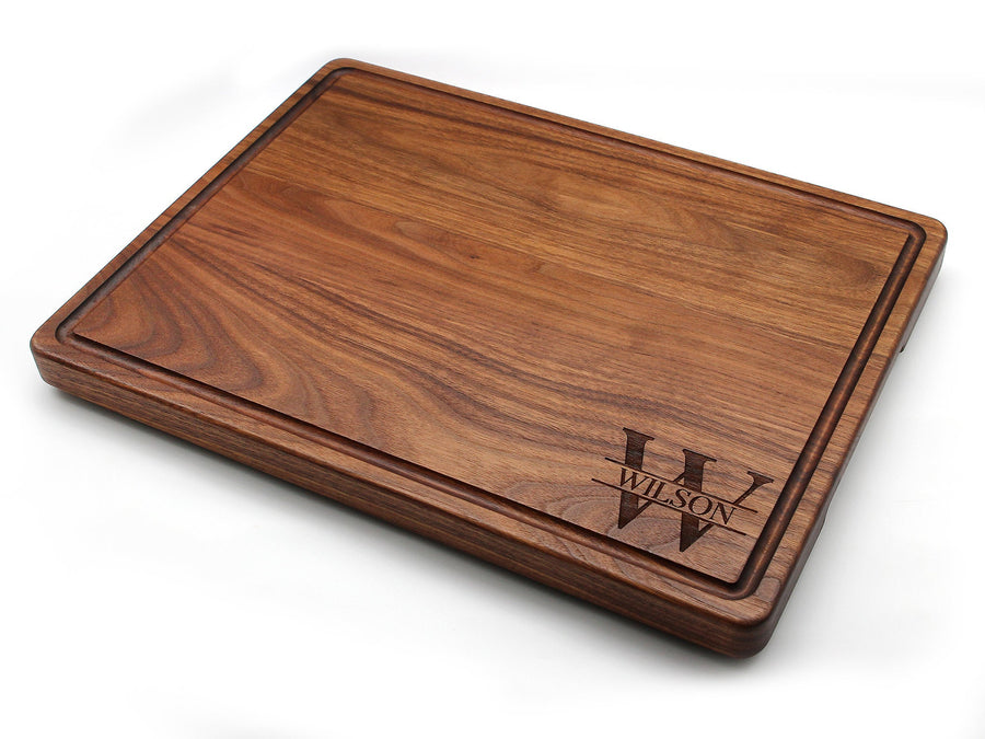 Thick walnut board with a juice groove and a corner monogram