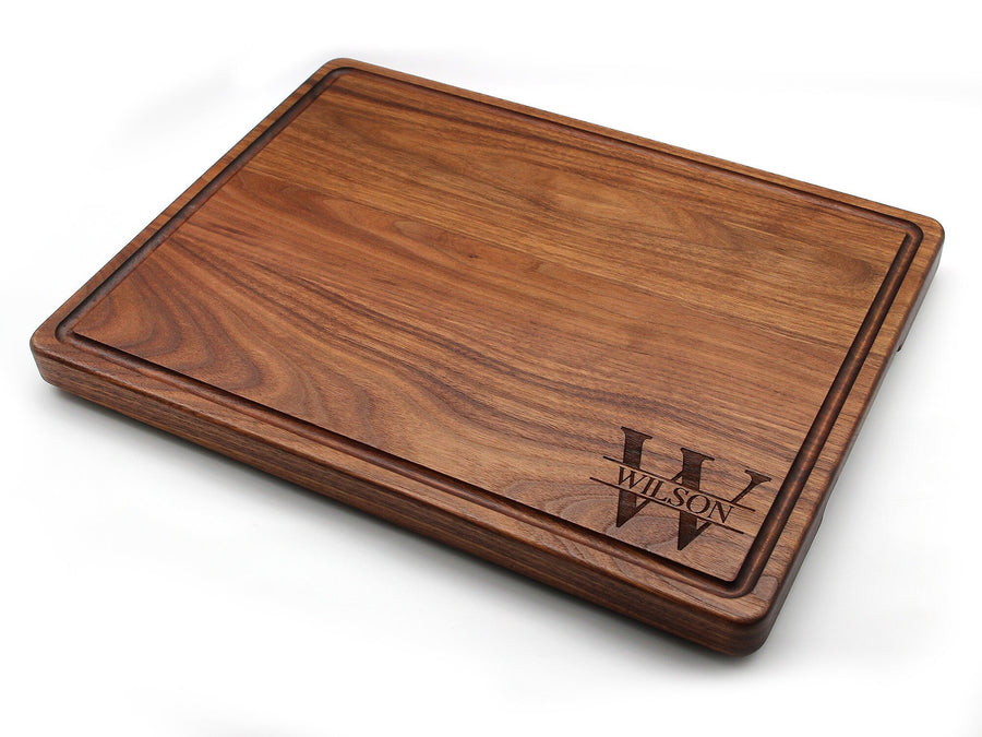 Thick walnut board with a juice groove and a corner monogram