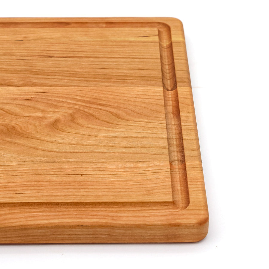 Cherry board corner detail showing a perimeter juice groove