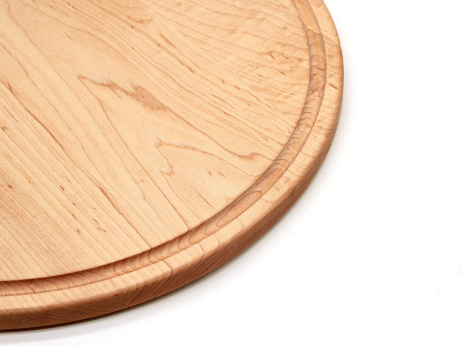 Close view of the circular groove near the edge of a maple board