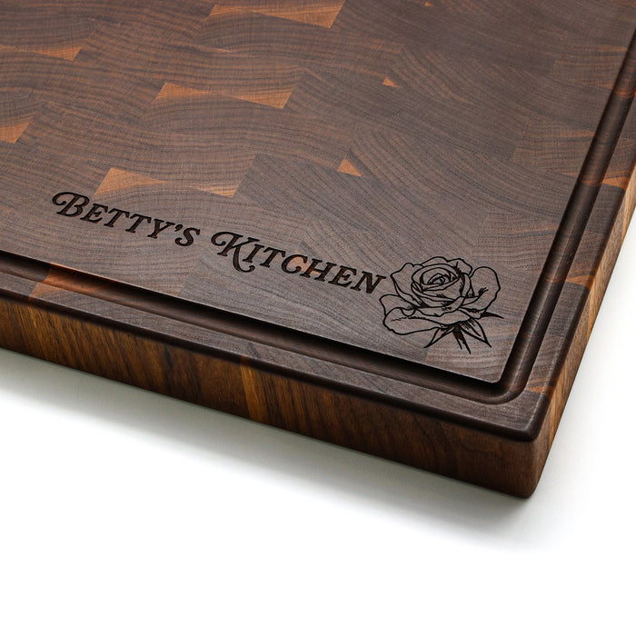 Walnut end-grain board corner engraved with an example kitchen name