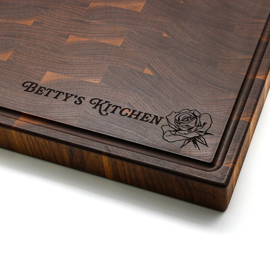 Walnut end-grain board corner engraved with an example kitchen name