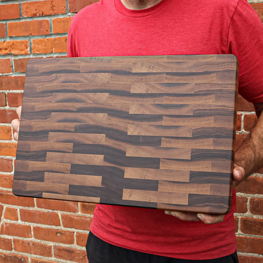 Calico walnut butcher block held upright to show its varied block pattern