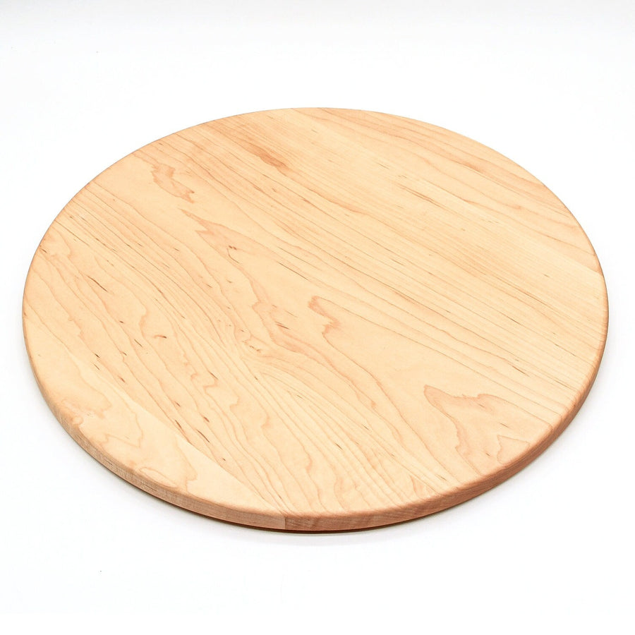 Round maple cutting board shown on a white background