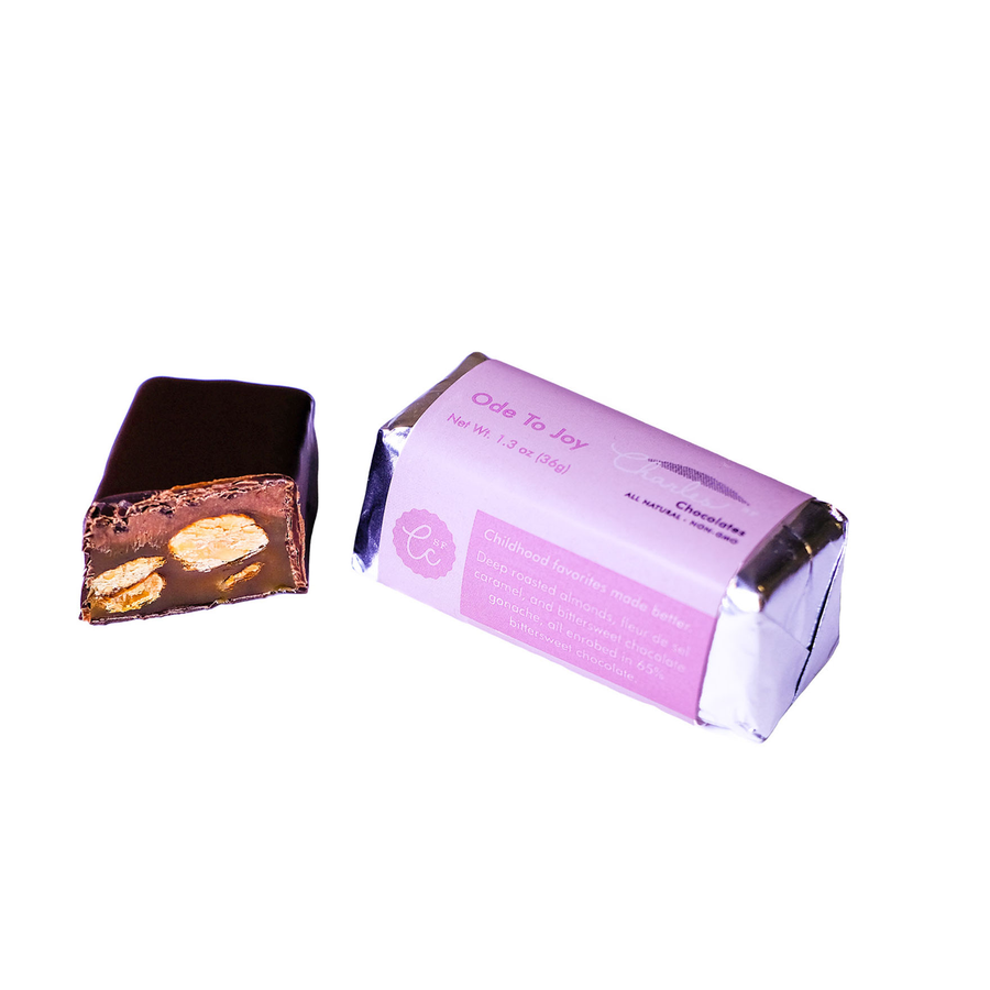 Ode To Joy Almond Caramel & Chocolate Ganache Bar beside its opened wrapper