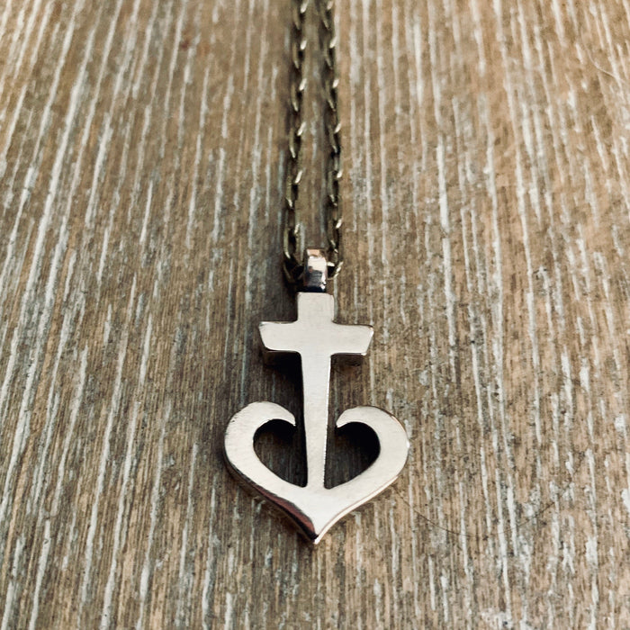 Anchored Heart necklace against a wooden background