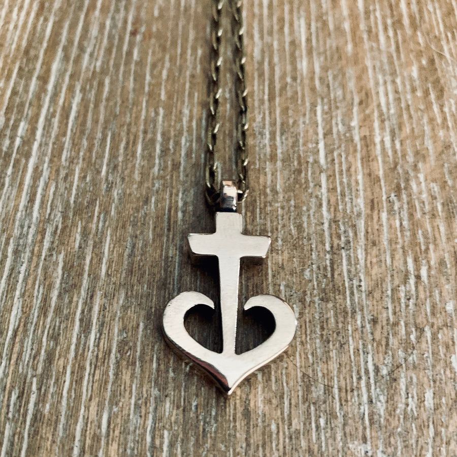 Anchored Heart necklace against a wooden background