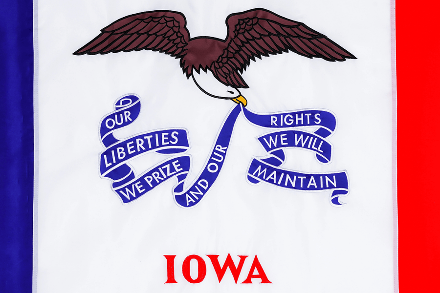 Iowa state flag close-up with bald eagle motto and Iowa lettering