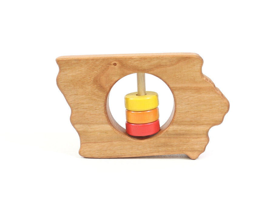 Iowa state-shaped cherry wood baby rattle with colored center disks