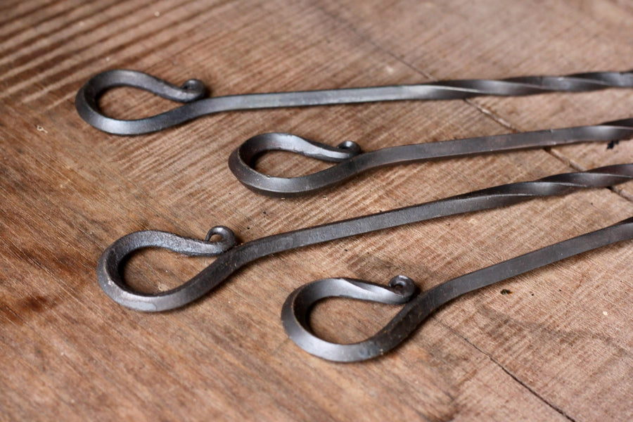 Looped handles of hand-forged steel skewers