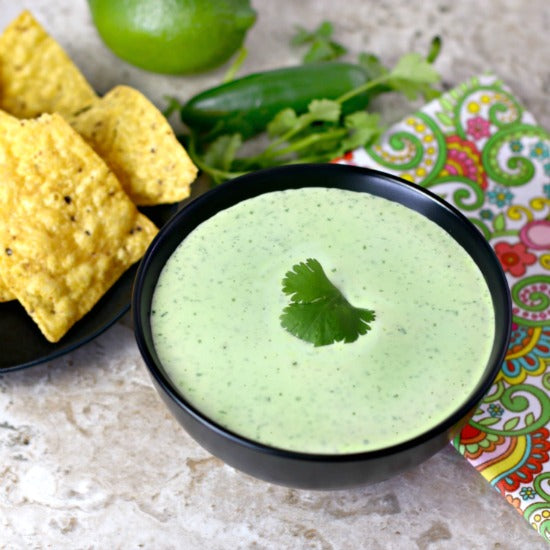 Green Jalapeno Lime dip with tortilla chips and lime