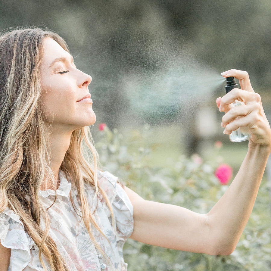 Person misting Rose Toner outdoors