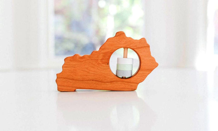Kentucky state-shaped cherry wood baby rattle with colored center disks