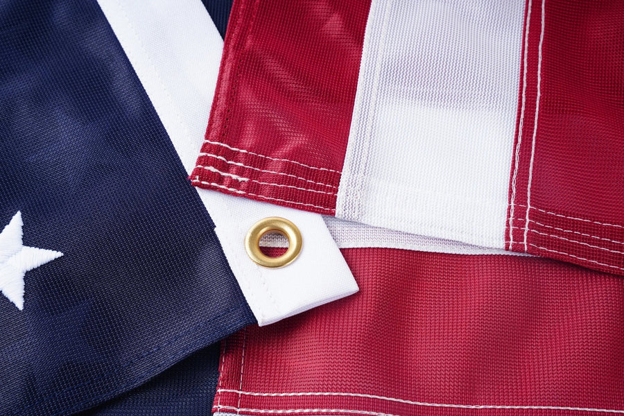 Close-up of knitted polyester American flag with brass grommet and reinforced stitching