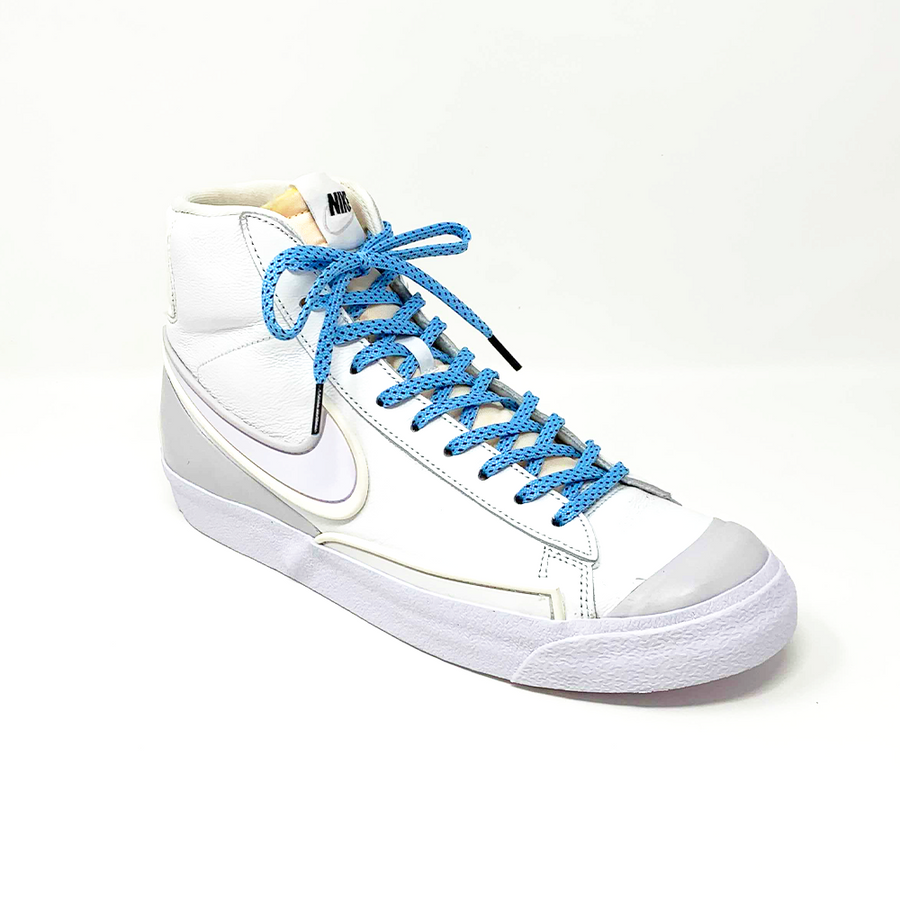 Light Blue & Black ticked flat shoelaces laced into a white high-top sneaker