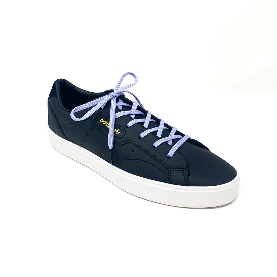 Lavender & Electric Green ticked flat shoelaces laced into a black low-top sneaker