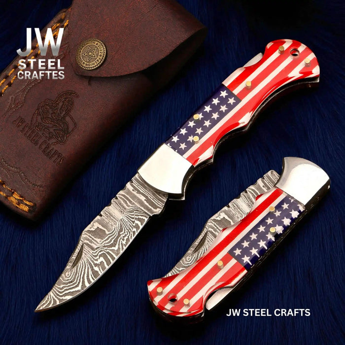 Damascus folding pocket knife with American flag handle and decorative patterned blade