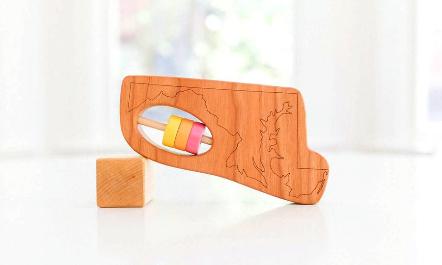 Maryland state-shaped cherry wood baby rattle with colored center disks