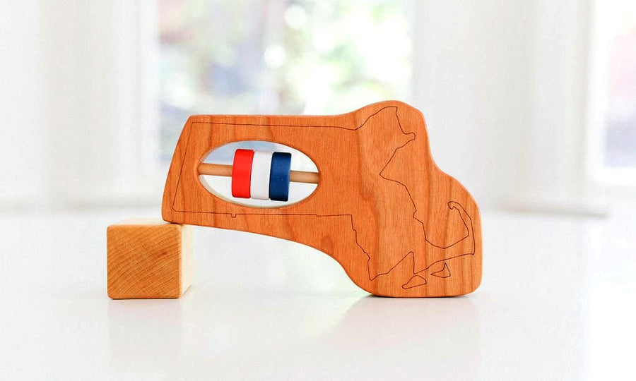 Massachusetts state-shaped cherry wood baby rattle with colored center disks