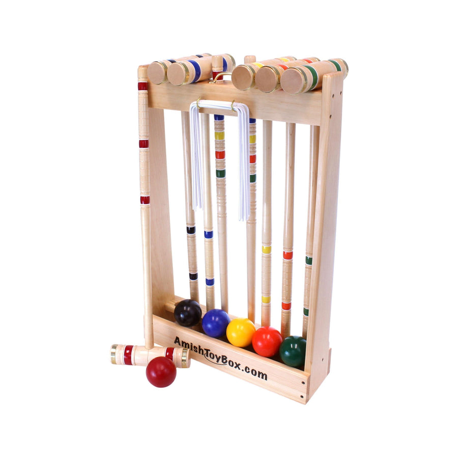Croquet mallets and balls arranged with the set’s storage equipment