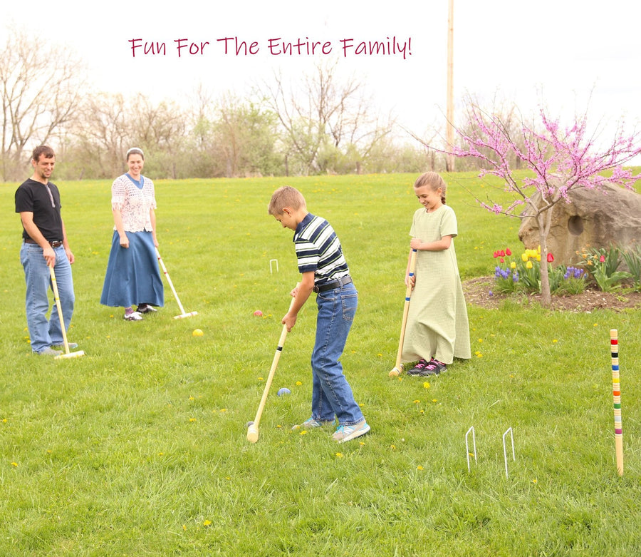 Family playing croquet together on a lawn