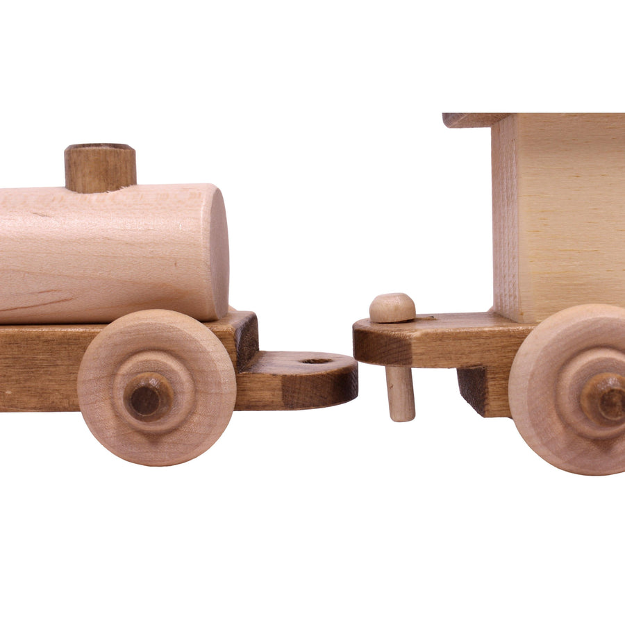 Close-up of the wooden connector between toy train cars