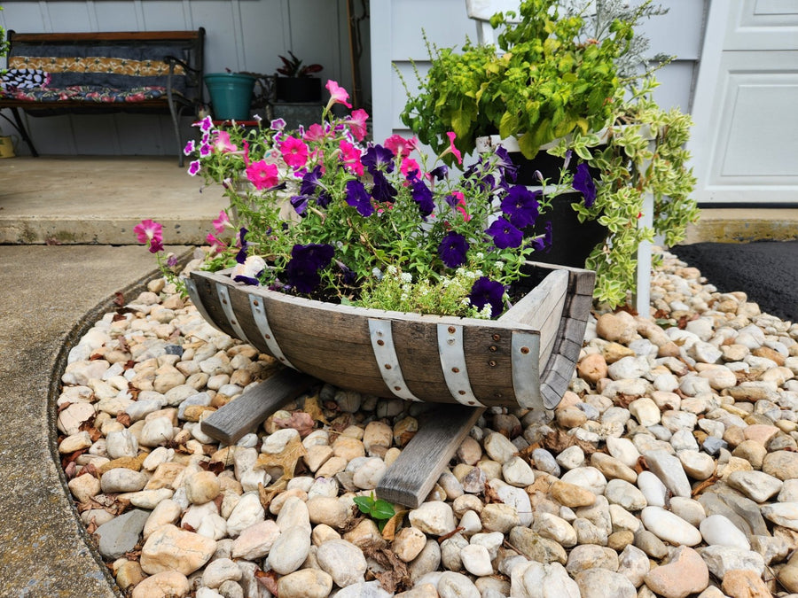 Reclaimed wooden barrel planter filled with flowers outdoors