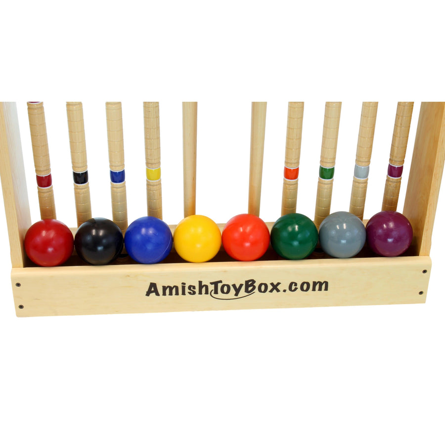 Croquet mallets and balls arranged with the set’s storage equipment