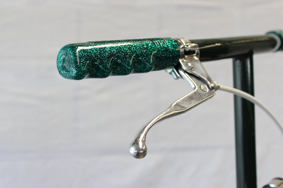 Close-up of a kick-scooter handlebar and hand brake