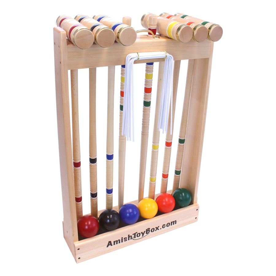 Croquet mallets and balls arranged with the set’s storage equipment