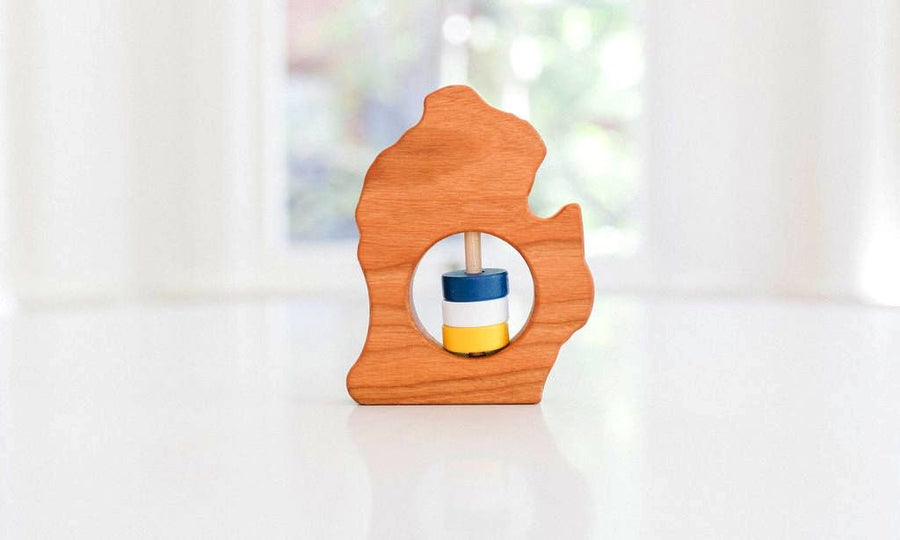 Michigan (Lower Peninsula) state-shaped cherry wood baby rattle with colored center disks