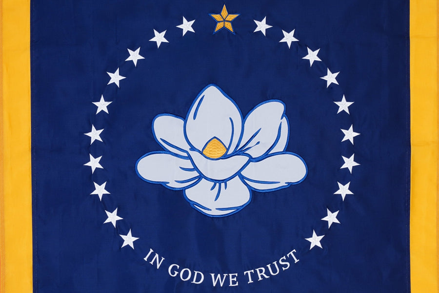 Mississippi state flag close-up with magnolia stars and In God We Trust