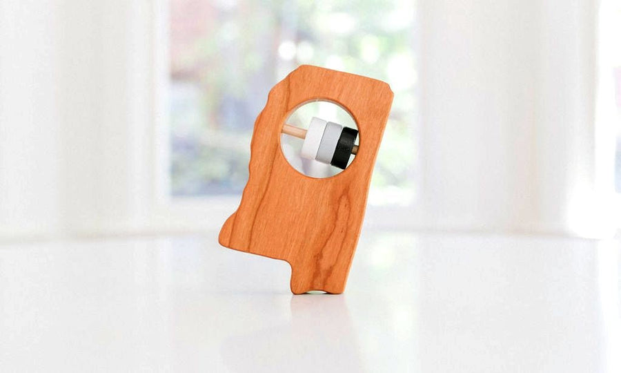 Mississippi state-shaped cherry wood baby rattle with colored center disks