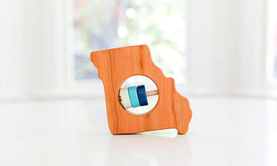 Missouri state-shaped cherry wood baby rattle with colored center disks