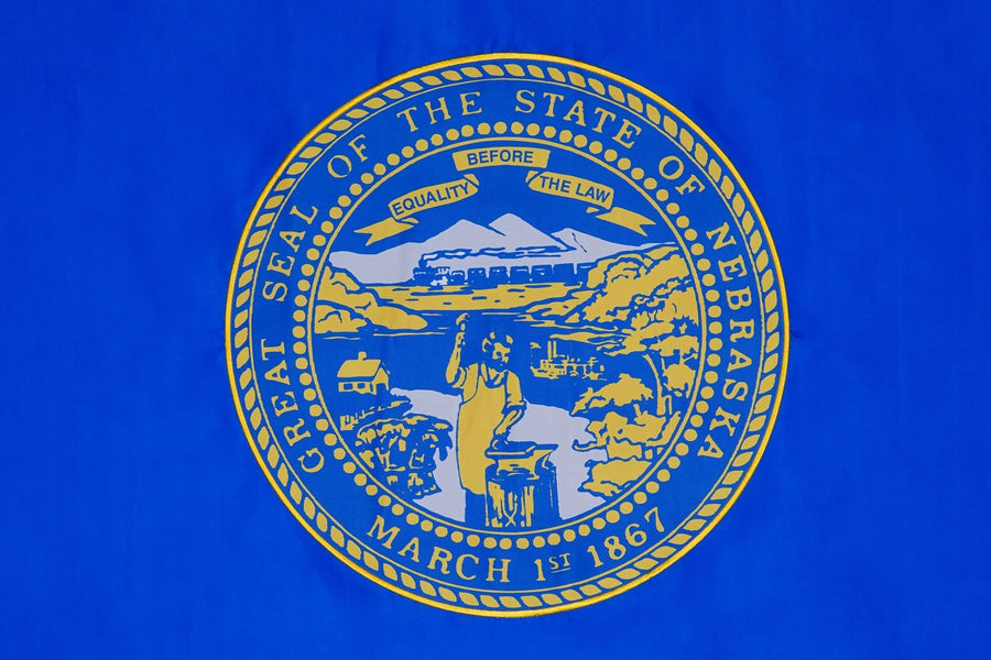 Nebraska state flag close-up with gold Great Seal on blue field