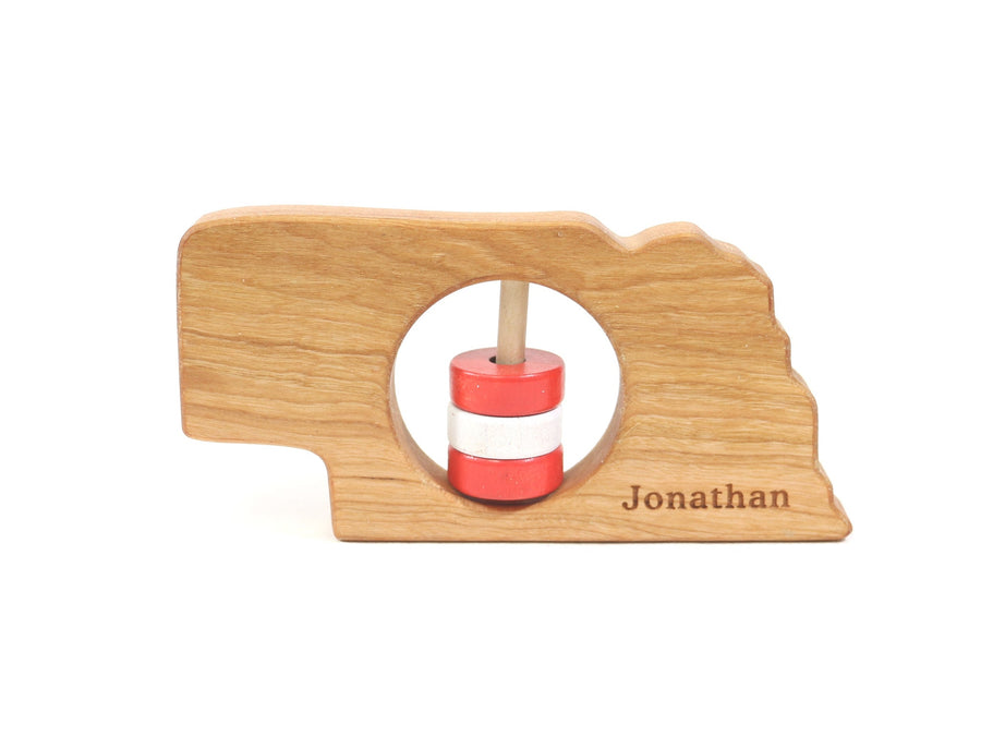 Nebraska cherry wood rattle with an example of engraved personalization