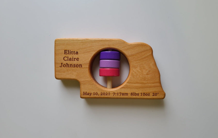 Nebraska cherry wood rattle with an example of engraved personalization