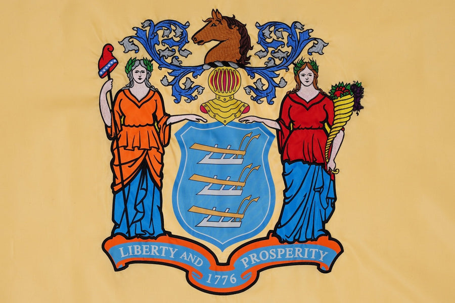 New Jersey state flag close-up with Liberty Prosperity coat of arms on buff field