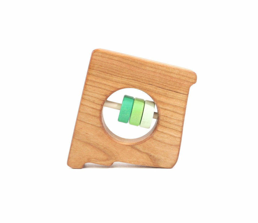 New Mexico state-shaped cherry wood baby rattle with colored center disks