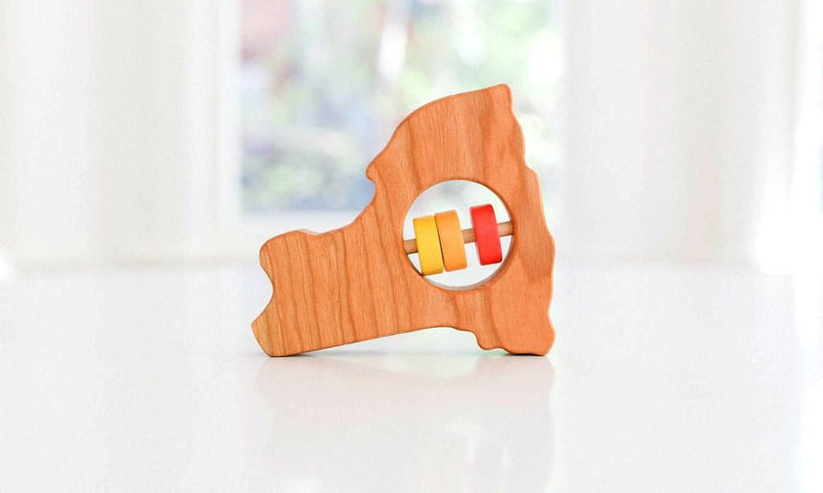 New York state-shaped cherry wood baby rattle with colored center disks