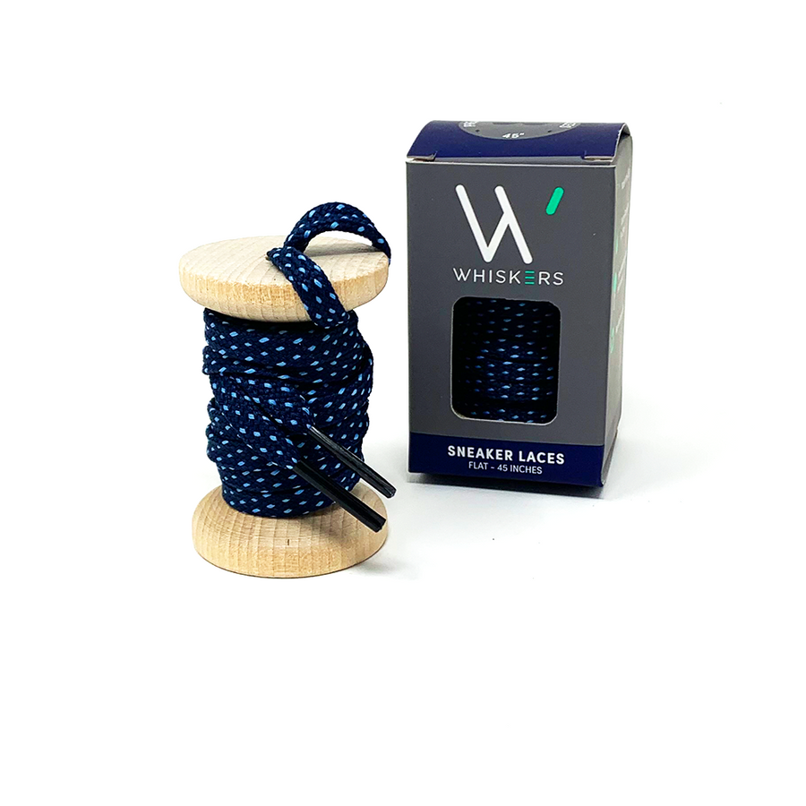 Navy & Light Blue ticked flat shoelaces on a wooden spool beside the retail box