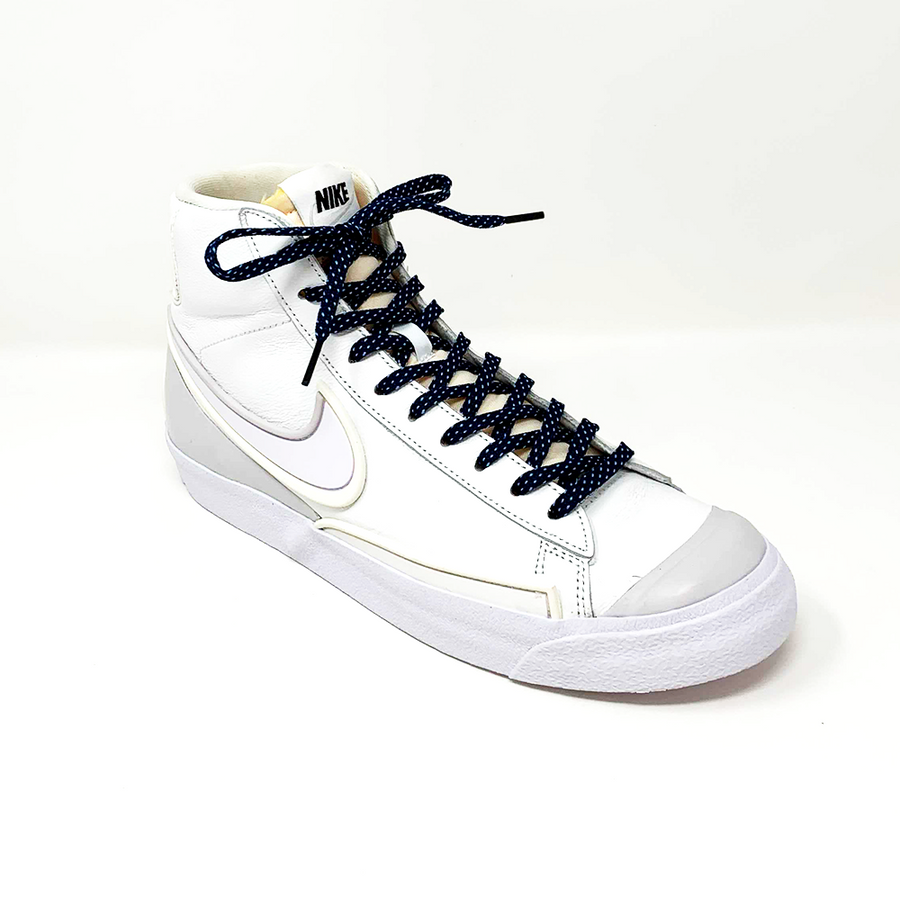 Navy & Light Blue ticked flat shoelaces laced into a white high-top sneaker
