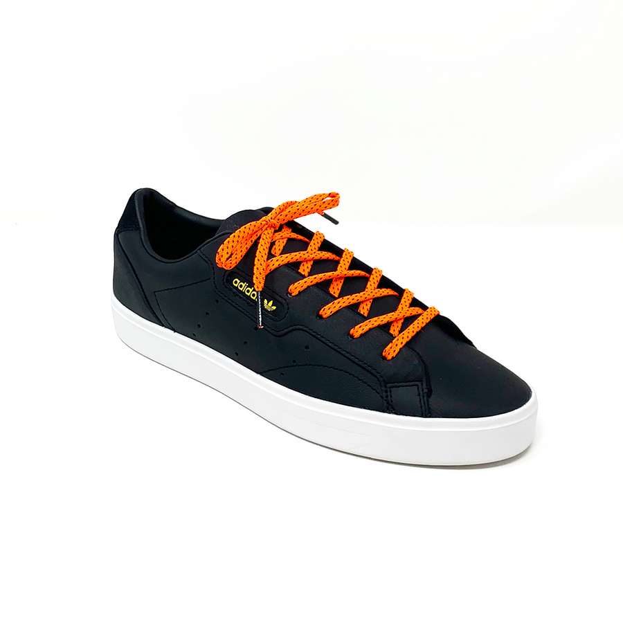 Neon Orange & Navy ticked flat shoelaces laced into a black low-top sneaker