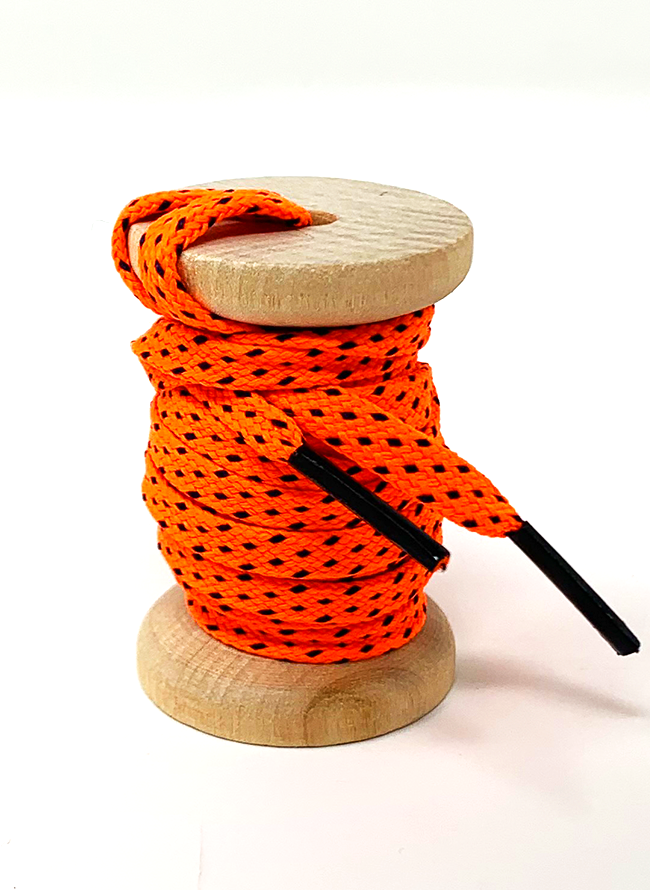 Neon Orange & Navy ticked flat shoelaces on a wooden spool