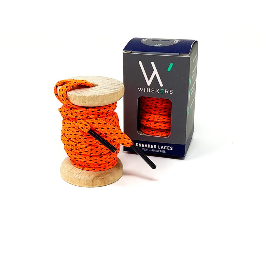 Neon Orange & Navy ticked flat shoelaces on a wooden spool beside the retail box