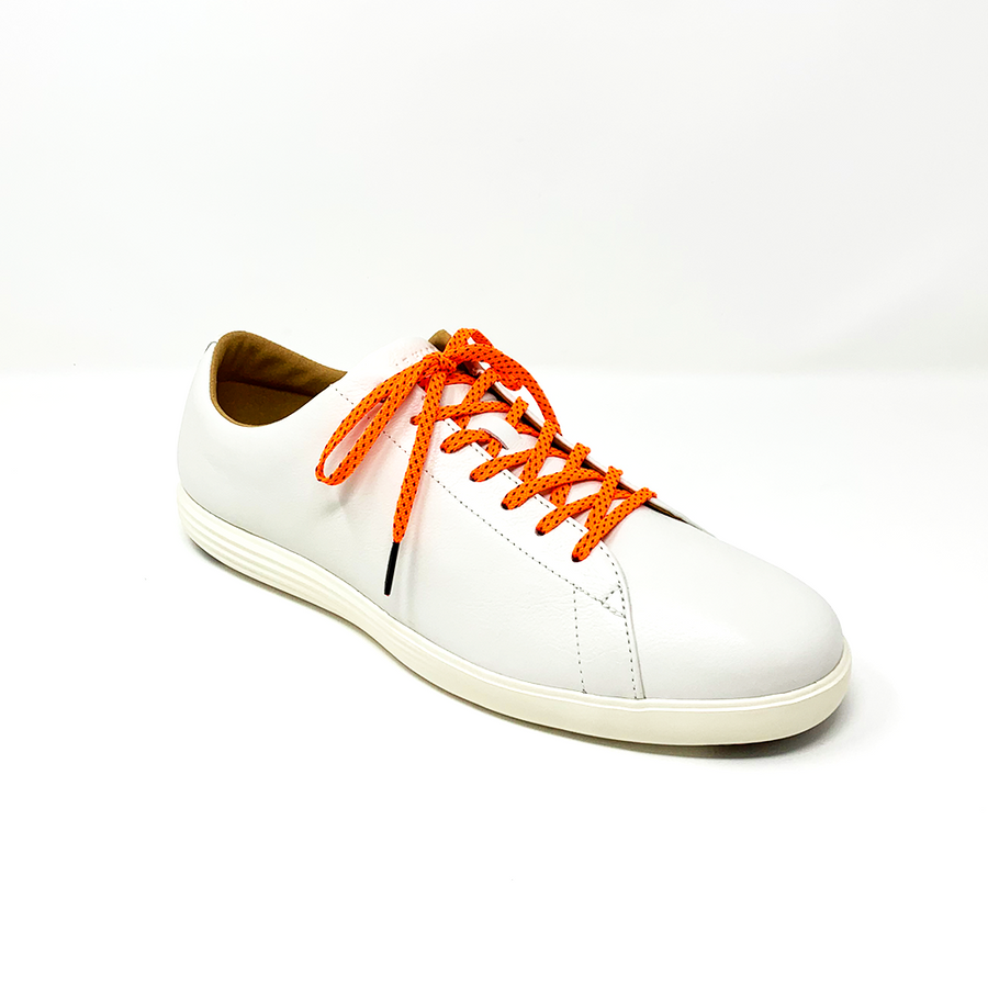 Neon Orange & Navy ticked flat shoelaces laced into a cream low-top sneaker
