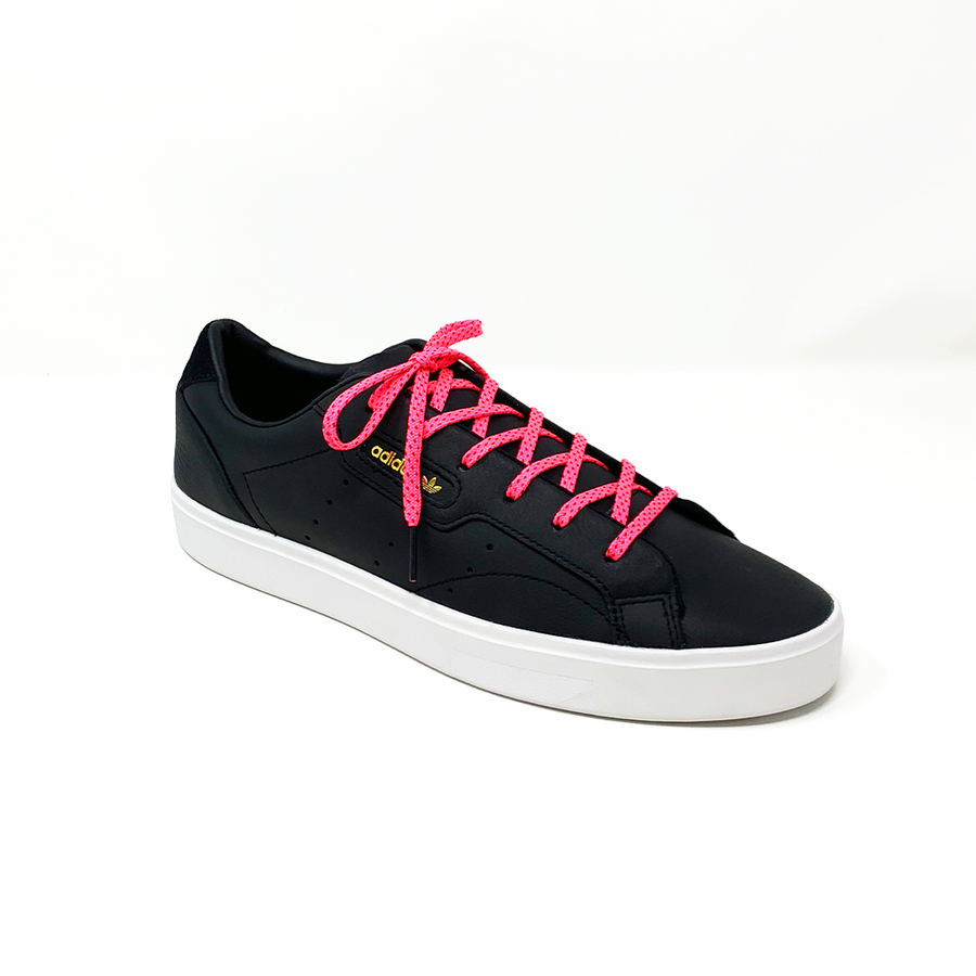 Neon Pink & Red ticked flat shoelaces laced into a black low-top sneaker