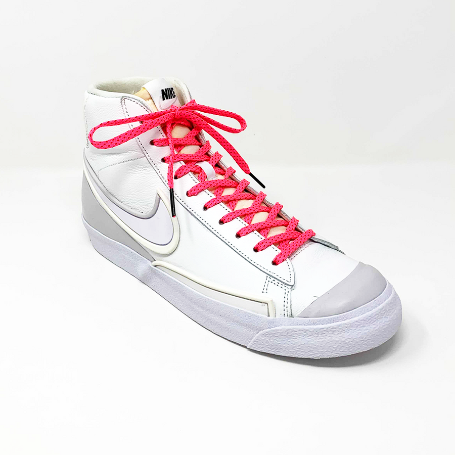 Neon Pink & Red ticked flat shoelaces laced into a white high-top sneaker