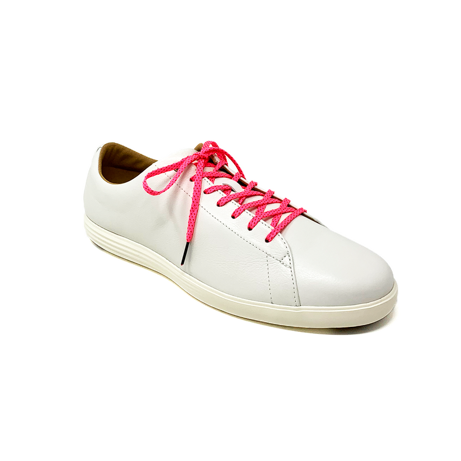 Neon Pink & Red ticked flat shoelaces laced into a cream low-top sneaker